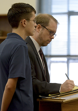 William Koberna and his attorney Paul Cristallo are addressed by Judge Barbara Oswick during an arraignment hearing on August 3 in the Kent Municipal Court. Koberna is no longer facing felony charges of inducing panic after making threats on Twitter of "shooting up" Kent State University. Koberna is now facing a charge of telecommunications harassment, a first-degree misdemeanor. Korberna's trial was pushed back after a short hearing on Wednesday. Photo by Matt Hafley.