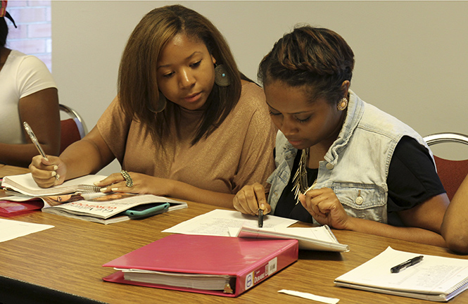 Modista members and senior fashion merchandising students Jenae Green and Lexi Farley discuss models and designers in the Student Center on Sept. 12 for their upcoming fashion show in November. Green is the president of Modista and Fairley handles the marketing. Photo by Adrianne Bastas.