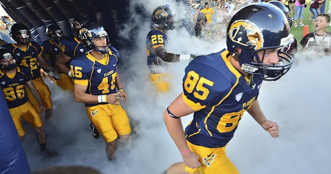 The Kent State football team runs out to the field at Dix Stadium on Aug. 30 ready to battle against Towson. Kent State won the game 41-21. Photo by Jacob Byk.