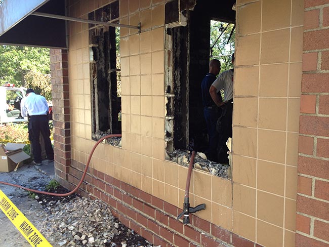 Workers wade through damage at the Family &amp; Community Services building Wednesday. Photo by Rex Santus.