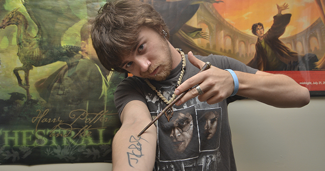 Stephen Petrick, sophomore fine arts major, in his apartment in Kent on Thursday. Petrick won the Guinness World Records for the most Harry Potter paraphernalia, which he has been collecting for 13 years as of November. Photo by Jacob Byk.