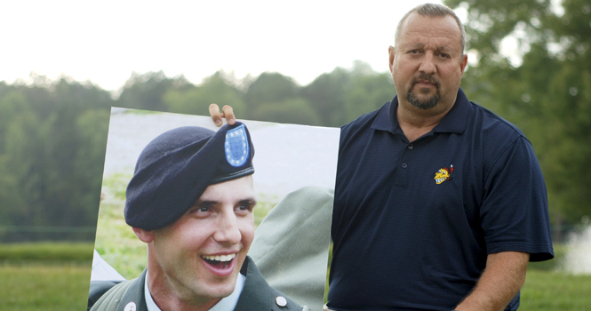 Scott Hamilton holds a picture of his late son, Adam. Scott met with President Obama on Wednesday before Obama's speech to Kent State students at the M.A.C. Center. Photo by Matt Hafley.