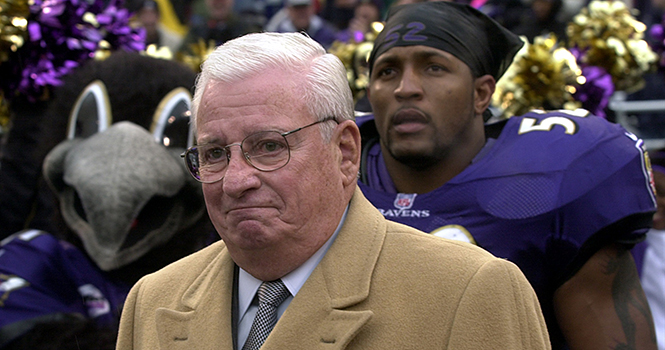 Baltimore Ravens owner Art Modell is escorted onto the field by linebacker Ray Lewis (52) before the Ravens faced San Diego Sunday, December 10, 2000. Modell was honored by his team for his 40-year association with the NFL. Photo by George Bridge