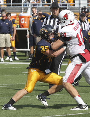 Senior safety Luke Wollet blocks a Ball State offensive player during Kent's 45-43 win over the Cardinals on September 29. Photo by Brian Smith.