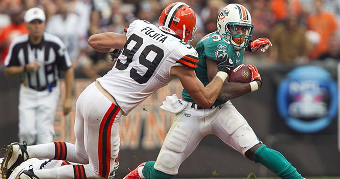 Miami Dolphins running back Daniel Thomas plants his foot to get around Cleveland Browns linebacker Scott Fujita in the fourth quarter at Cleveland Browns Stadium in Cleveland, Ohio, Sunday, September 25, 2011. The Browns defeated the Dolphins, 17-16. Photo by Joe Rimkus Jr./Miami Herald/MCT.