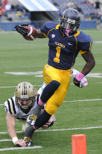 Senior running back Dri Archer defends the ball from a Western Michigan player during the first half of Saturday's Homecoming game. The Flashes triumphed 41-24. Photo by HANNAH POTES.