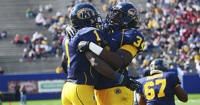 Dri Archer, senior runningback, and Trayion Durham, sophomore runningback, celebrate after Archer scored a touchdown during the game against Ball State on Sept. 29. The Flashes won 45-43. Photo by NANCY URCHAK.