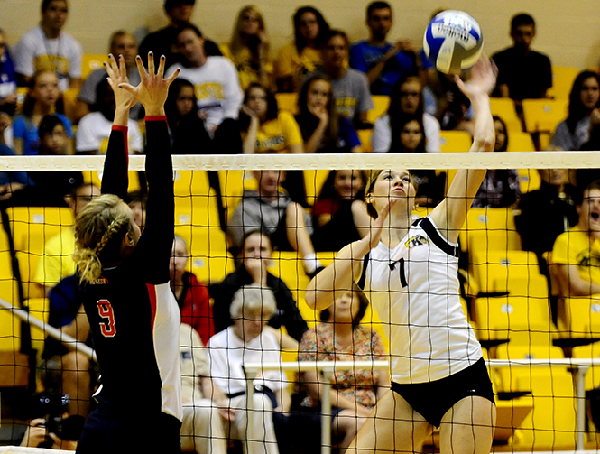 Freshman Kelly Hutchison spikes the ball over the net during Friday's game against Liberty. Photo by HANNAH POTES.