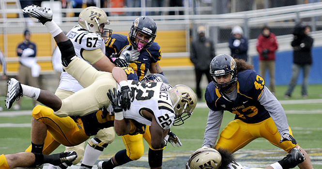 Sophomore wide receiver Skevo Zembillas tackles a Western Michigan player to the ground during KSU's homecoming game Saturday afternoon. Photo by Hannah Potes.