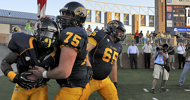 Senior running back Dri Archer is congratulated by offensive lineman Phil Huff during Kent's game against Towson. Photo by Phil Botta.