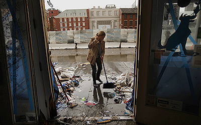 Amanda Zink starts to clean up the store she owns called "The Salty Paw," which was completely flooded on the waterfront of lower Manhattan, Tuesday, October 30, 2012. The tape on the windows was no match for the strength of the storm. Hurricane Sandy caused major damage to New York City and surrounding areas. (Carolyn Cole/Los Angeles Times/MCT.