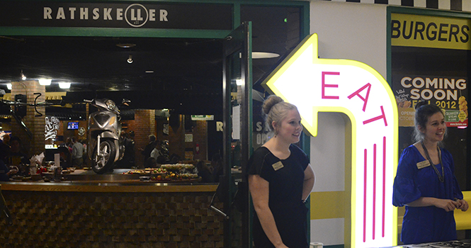 Brittny Counts, graphic designer for Dining Services, and Chelsea McClelland, marketing associate for dining Services, greet guests at the Quaker Steak &amp; Lube VIP event in the Student Center on Oct. 16. The event is the kick-off to the actual opening on Oct. 17. Photo by Nancy Urchak.