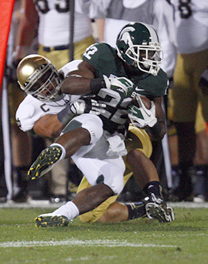 Michigan State's Larry Caper (22) is tackled by Notre Dames' Manti Te'o during first-quarter action on Saturday, September 15, 2012, at Spartan Stadium in East Lansing, Michigan. Photo by Kirthmon F. Dozier/Detroit Free Press/MCT.