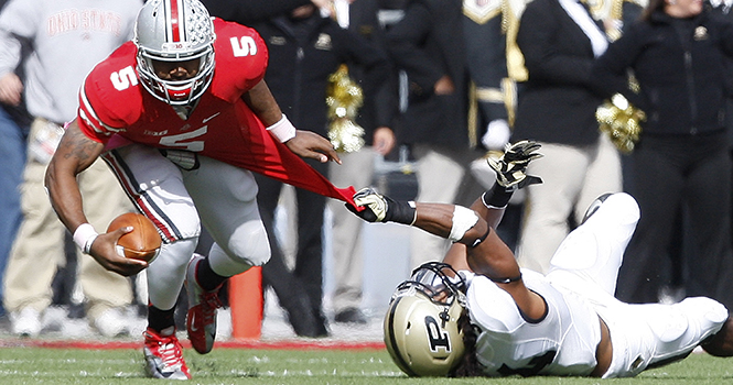 Ohio State Buckeyes quarterback Braxton Miller (5) has his jersey ripped as he tries to escape the tackle by Purdue Boilermakers safety Max Charlot (34) during the third quarter of an NCAA football game at Ohio Stadium in Columbus, Ohio on Saturday, October 20, 2012. The Ohio State Photo by ADAM CAIRNS.