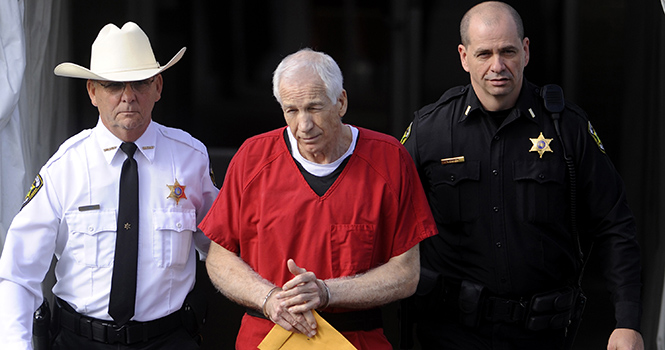 Jerry Sandusky, center, is escorted from his sentencing at the Centre County Courthouse in Bellefonte on Tuesday, October 9, 2012. Sandusky, maintaining his innocence, was sentenced Tuesday to at least 30 years in prison, effectively a life sentence, in the child sexual abuse scandal that brought shame to Penn State and led to coach Joe Paterno's downfall. (MCT)