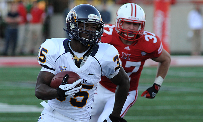 Kent State freshman running back Julian Durden runs the ball past Miami University senior linebacker Pat Hinkel in a game Miami at Yager Stadium, Oxford, OH, on Saturday, Nov 10. Photo by Kristin Bauer.