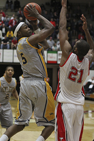 Kent State's Chris Evans (5) takes a jump shot while being defended by Youngstown State's Damian Eargle (21) during the second half of the Flashes' 85-78 win over Youngstown State on Nov. 28, 2012, in the Beeghly Center on the campus of Youngstown State University. Photo by Dustin Livesay.