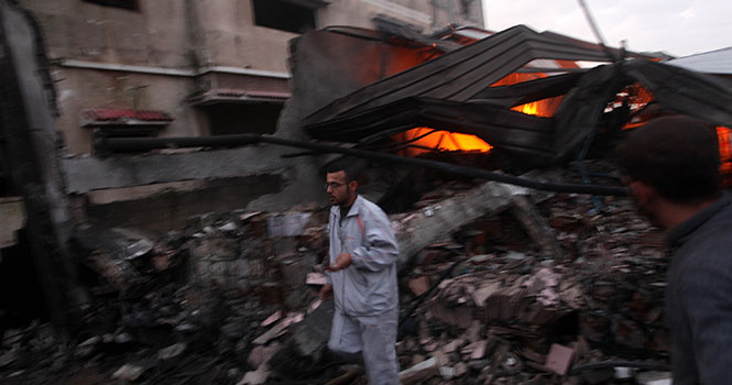 Palestinians try to extinguish a fire following an Israeli strike in Zeitun, on the outskirts of Gaza City, on Saturday, November 17, 2012. Israeli aircraft bombed Hamas government buildings in Gaza on Saturday, including the prime minister's office, ahead of a possible ground invasion. Photo courtesy of MCT Campus.