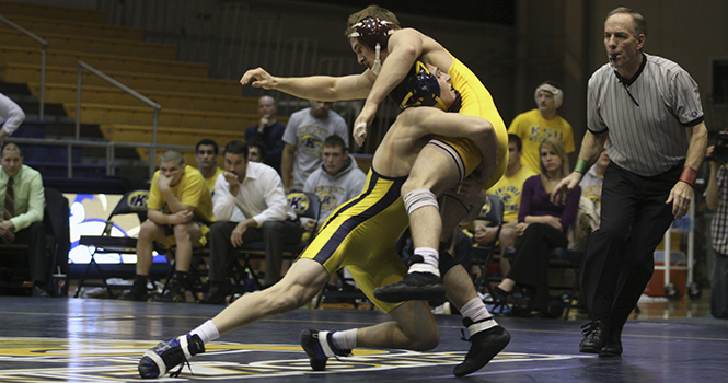 149 lb. Freshman Ian Miller takes down his Central Michigan opponent during the meet on Jan. 29. Kent State beat Central Michigan 22-13 to remain unbeaten in the Mid-American Conference. Photo by COTY GIANNELLI.