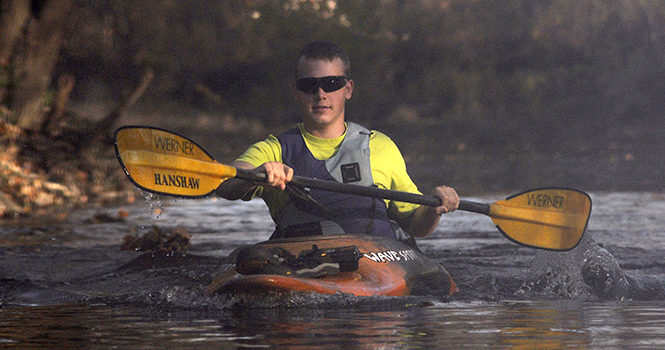 Adam Hanshaw, 22, a veteran who very recently just arrived back in the United States from Afghanistan, paddles a kayak on the Cuyahoga River as part of the River Run, on Oct. 24. Photo by Jacob Byk