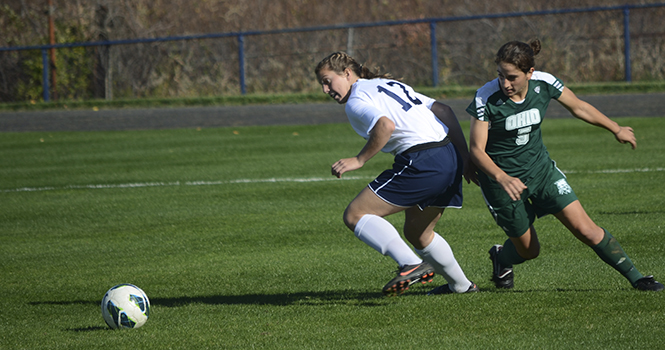 Freshman midfielder Ashley Mahoney pivots along side Ohio's Cathryn Rogers before meeting the ball. The Golden Flashes beat the Bobcats 3-0 on Thursday. Photo by MARIELLE FORREST.