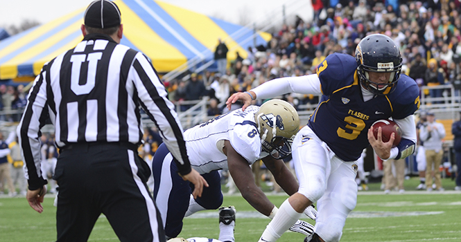 Spencer Keith, senior quarterback, scores a touchdown during the second quarter of the rivalry game against Akron on Nov. 3. The Flashes beat the Zips 35-24. Photo by NANCY URCHAK.