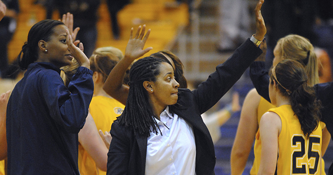 The new women's basketball head coach Danielle O'Banion encourages the lady Flashes toward the end of their game against the Cincinnati Bearcats on Monday, Nov. 19. The Flashes lost with a final score of 59-41. Photo by Jenna Watson.