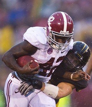 Alabama Crimson Tide running back Eddie Lacy (42) picks up a few more yards as Missouri Tigers linebacker Will Ebner (32) hangs on for reinforcements in the fourth quarter at Faurot Field in Columbia, Missouri, Saturday, October 13, 2012. Alabama beat Missouri, 42-10. Photo by Shane Keyser/Kansas City Star/MCT