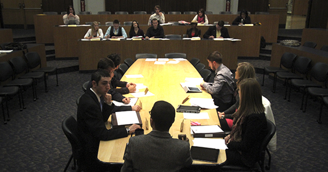 Evan Gildenblatt, the executive director for USG, speaks to fellow student government members in the Governance Chambers inside the Student Center on Nov. 28. Photo by Brian James Smith.