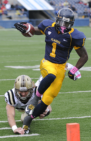 Senior running back Dri Archer defends the ball from a Western Michigan player during the first half of Kent's Homecoming game. The Flashes triumphed 41-24. Photo by Hannah Potes.