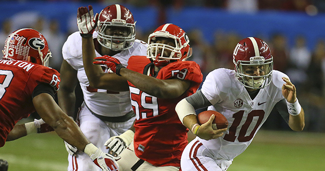 Alabama quarterback AJ McCarron (10) breaks away from Georgia linebacker Jordan Jenkins on a quarterback keeper in the SEC championship game at the Georgia Dome in Atlanta, Georgia, on Saturday, December 1, 2012. Alabama won, 32-28. Photo by CURTIS COMPTON.