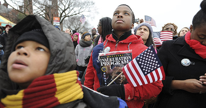 Steven Raigns, 10, of Petersburg, Virginia, and Sedrik Bailey, 16, Quantico, Virginina stand on the National Mall and listen to President Barack Obama make remarks and take the oath of office, Monday, January 21, 2013 in Washington, D.C. Photo courtesy of MCT Campus.