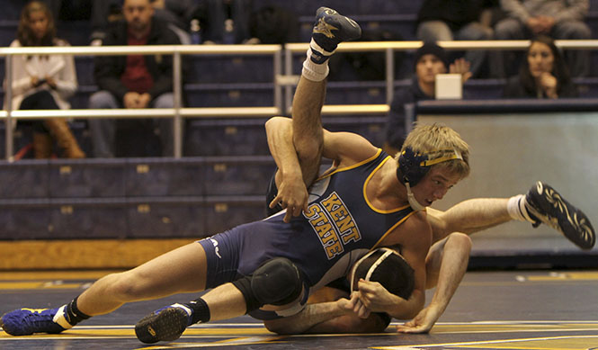 Sophomore Nick Carr pins down his opponent in the MACC Jan. 20. Kent State defeated Clarion 26 to 10. Photo by ADRIANNE BASTAS.