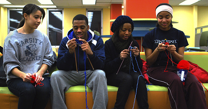 Avery Bounds (far left), president of the student-run organization "Knitting for Those in Need", teaches Marteze Roper, a junior finance major, Brooklyn Hill, a sophmore psychology major, and Katrinka Stephens, a sophmore zoology major, how to knit a scarf. "Knitting for Those in Need" had its first meeting on January 23, 2012. Photo by MELANIE NESTERUK.