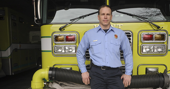 Bill Myers, a Kent Firefighter, poses in the Kent Fire Station Two on Rockwell St. in downtown Kent on Jan 13. Myers was awarded recently for his brave actions during a house fire on Nov. 10, whereMyers pulled an injured comrade from a burning basement. Photo by JACOB BYK .