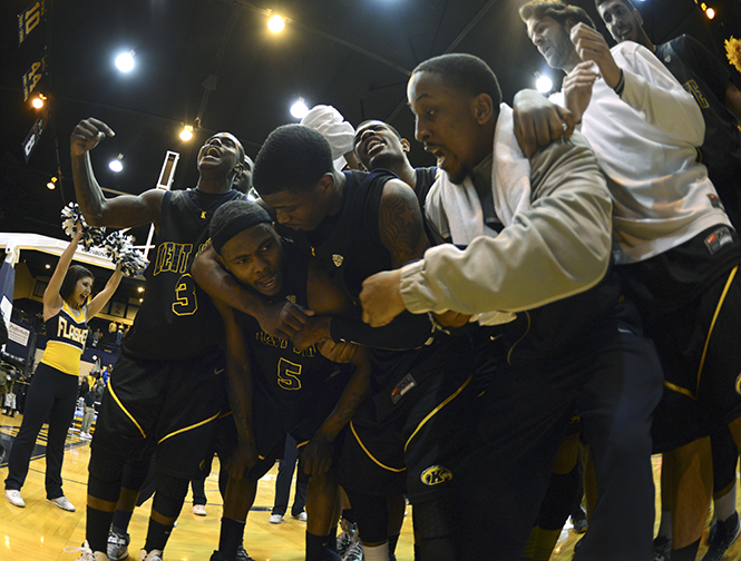 The Kent State men's basketball team celebrates with Chris Evans after he made the winning basket in overtime against Buffalo on Wednesday, Feb. 27. The final score was 83-81. Photo by Jenna Watson.