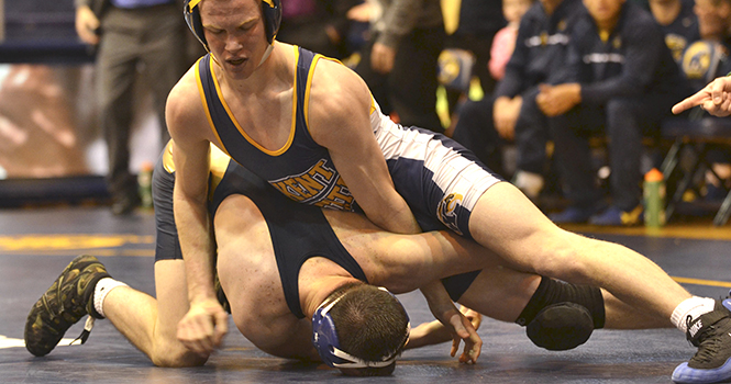 Freshman Brandon Taylor pins down his opponent during the match against Clarion in the MAC center on Jan. 20. The team will travel to Ypsilanti, Mich. to wrestle against Eastern Michigan this weekend. Photo by Chloe Hackathorn.