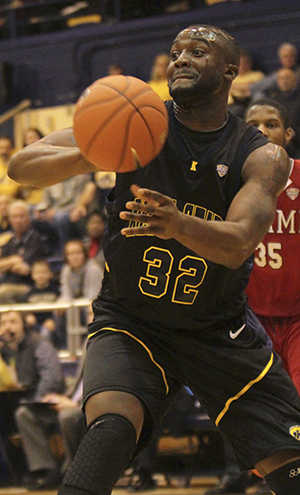 Junior Melvin Tabb passes the ball at Kent's winning game against Miami Wednesday, Feb. 13 in the M.A.C.C. Center. Photo by Yolanda Li.