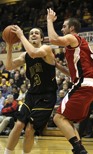 Junior forward Mark Henniger shoots the ball at Kent State's game against Miami on Feb. 13. The Flashes won with a final score of 87-70. Photo by Chloe Hackathorn.