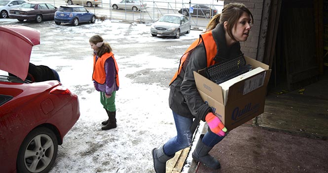 Sophomore Interior Design major Savanah Dimovski brings in new boxes at the Zero Landfill event in Akron on Saturday, Feb. 9. Dimovski volunteers for her major as part of the Interior Design Student Collaborative. Zero Landfill is a chance for people to contribute scrap crafting items, often interior design related, and to take any items that interest them in prevention of sending it to landfills instead. Photo by Jenna Watson.