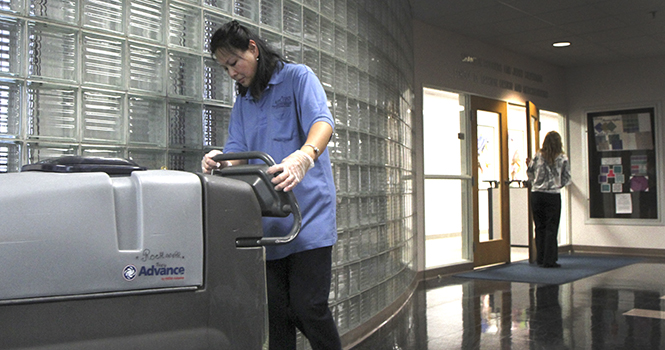 Beth Causey, 43, custodian at Kent State, operates a floor scrubber in Rockwell Hall Wednesday, Jan. 30. Causey has worked for the university's custodial services for five years. Photo by Shane Flanigan.