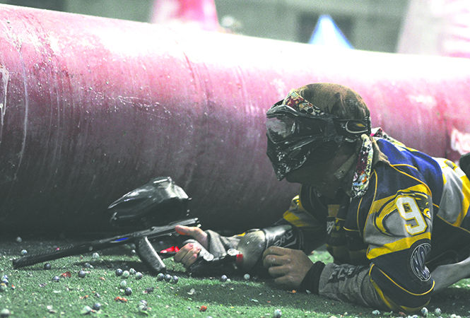 Adam Michl, accounting major, takes cover in "the snake" during a paintball battle on Monday, Feb. 25, 2013. Photo by JACOB BYK.