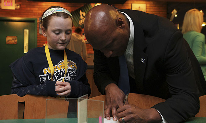 Kent State football coach Paul Haynes signs an autograph for Sophia Waiz, 8, during National Signing Day Wednesday, Feb. 6 at Quaker Steak and Lube in the student center. Photo by Shane Flanigan.