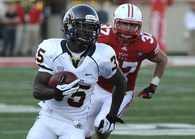 Kent State freshman running back Julian Durden runs the ball past Miami University senior linebacker Pat Hinkel in a game against Miami at Yager Stadium on Saturday, Nov. 10, 2012. Photo by Kristin Bauer. Photo by Kristin Bauer.