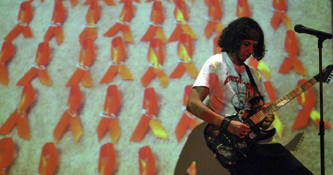 Alfred Shaker performs several songs on the electric guitar, including Crazy Train by Ozzy Osbourne, during Lyrics and Conversation on February 26. Lryics and Conversation was put on by the Kent State chapter of To Write Love on. Photo by Melanie Nesteruk.