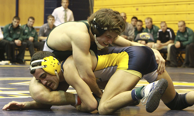 Senior Stevie Mitcheff finishes with a 11-5 victory over Ben Willeford from Cleveland State University. Kent State defeated Cleveland State 31-30 on Friday night at the M.A.C Center. Photo by Yolanda Li.