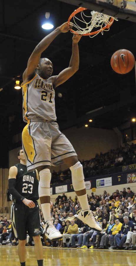 Kent State Men's Basketball forward Khaliq Spicer hangs from the rim aftering dunking during Kent State's game against Ohio University in the M.A.C. Center on Jan. 26, 2013. The Golden Flashes lost to the Bobcats, 69-68, with an intense last-second ending. Photo by Jessica Denton.