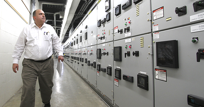 Peter Latkovic, university power plant manager, walks through the main switchgear room of Kent State's power plant located on Ted Boyd Drive across from the Student Recreation and Wellness Center. The facility's generators produce 13 megawatts of electricity, which is distributed throughout the campus. Photo by SHANE FLANIGAN.