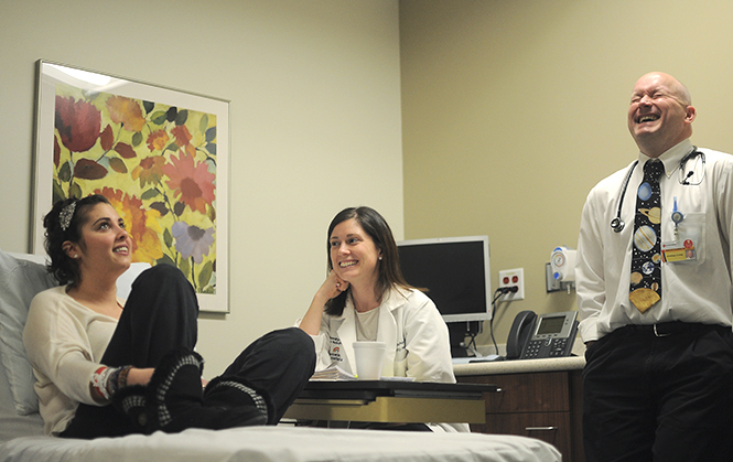 Gina Cortese sits in the pediatric cancer center with her nurse practitioner Kelly Laschinger and Dr. Duncan Stearns, at University Hospital in Cleveland on Feb. 27, waiting for her chemotherapy. Cortese purchased the tie that Dr. Stearns is wearing as a gift for the holidays. Photo by Jacob Byk.