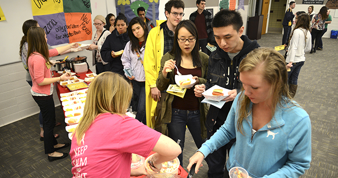 Students serve samples at the "America" stop for the Taste of the World event in Beall Hall on Monday, March 11. The event offered food samples from Italy, Mexico, Germany, Slovakia and Ireland. Photo by Jenna Watson.